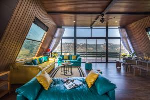a living room with a couch and a table at SaffronStays A Vantage, Panchgani in Panchgani
