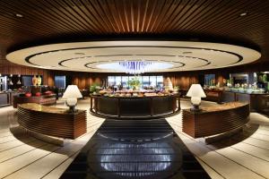 a lobby of a hotel with a bar at Conrad Singapore Orchard in Singapore