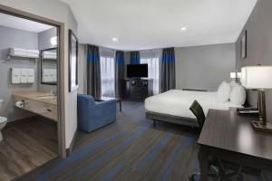 a hotel room with a bed and a desk at Days Inn by Wyndham Barrie in Barrie