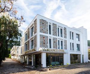 a white building with a sign that reads exchange office at Güllük Uno Elegance Otel in Gulluk