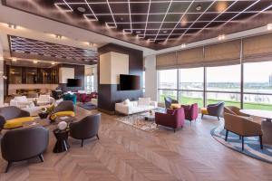 a lobby with a waiting room with couches and chairs at Hilton Samarkand Regency in Samarkand