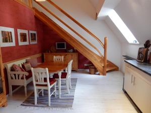 a dining room with a table and a staircase at Pension Waldesblick in Friedrichroda