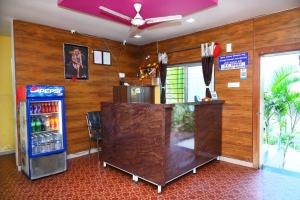a bar with a soda machine in a room at P P Lodging in Pune