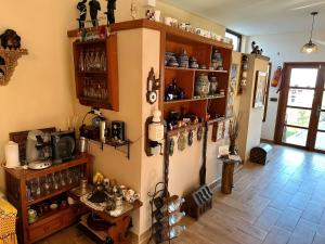 a living room with wooden floors and shelves with items at Les IRIS in Al Hoceïma