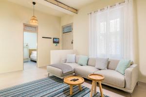 a living room with a couch and a table at MEDANO4YOU Surfers Cove Holiday Home in El Médano