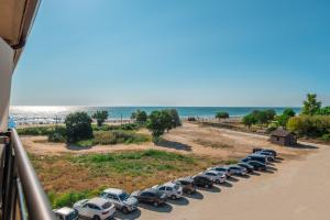a row of cars parked next to the beach at Veramar Hotel - All Inclusive & Free Beach in Kranevo