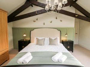 a bedroom with a large white bed with two night stands at Dant Y Llew in Bow Street