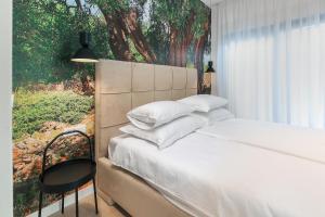a bedroom with a bed with a painting on the wall at Luxury Villa 360 - private heated pool in Novalja +113 photos