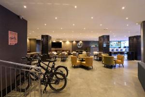 a restaurant with bikes parked in a room with tables and chairs at Catalonia Park Güell in Barcelona