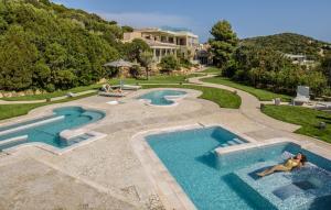 an image of two swimming pools in a resort at Chia Laguna - Hotel Village in Chia +31 photos