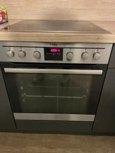a oven with a clock on it in a kitchen at 3 Room City Apartment 90m2 in Heilbronn