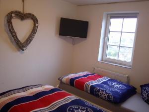 a bedroom with two beds and a heart mirror at Unseburg-Ferienwohnung 3 