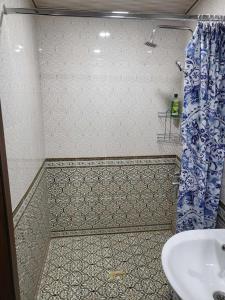 a bathroom with a sink and a shower curtain at SHAHNOZA GRAND in Samarkand