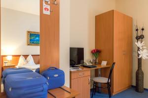 A bed or beds in a room at P4W Hotel Residence Szombathely