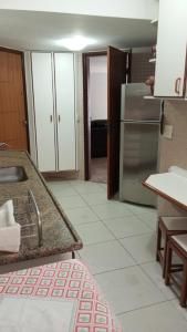 una cucina con lavandino e frigorifero di ferratti a Guarapari