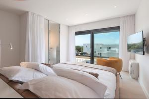 a bedroom with two beds and a large window at Luxury villa del Sol in Novalja +48 photos