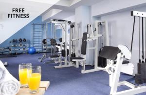 a gym with two glasses of orange juice on a table at COLORFACTORY SPA Hotel - Czech Leading Hotels in Prague
