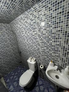 a bathroom with a toilet and a sink at Riad Fes Unique in Fès