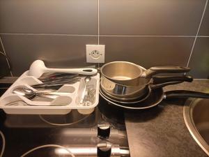 a stove top with a pot and pans on it at Dream Dwell Paris - Paris Expo Porte Versailles beautiful apartment with balcony in Issy-les-Moulineaux