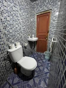 a bathroom with a toilet and a sink at Riad Fes Unique in Fès