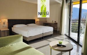 Voodi või voodid majutusasutuse Hotel Nessi Locarno toas