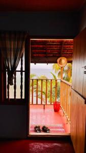 an open door to a porch with a view of the ocean at Manshore bay in Kannur