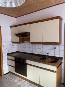 a kitchen with a sink and a stove at Shalom 