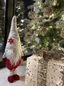 a santa claus figurine next to a christmas tree at Hotel 52 in Odesa