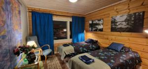 - une chambre avec deux lits, une chaise et une fenêtre dans l'établissement #casakivicco, à Leppävirta