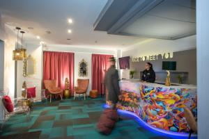 a man standing in front of a counter in a room at Casual Ilbira Granada by Casual Hoteles in Granada