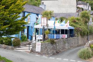 a blue building with signs on the side of a street at Caldey Island View - Sea Views and Log Burner in Penally