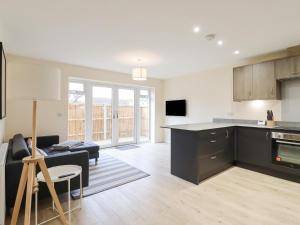 a kitchen and living room with a couch and a table at 21A Saville Road in Walton-on-the-Naze