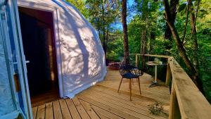 a porch of a tent with a chair on a deck at Llaimadomo in Melipeuco +6 photos