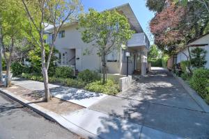 a white house with trees on the side of a street at Palo Alto 1br w parking wd walk to parks SFO-1638 in Palo Alto