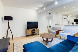 a living room with a blue couch and a tv at Cupertino 3br w patio backyard nr restaurants SFO-1636 in Cupertino