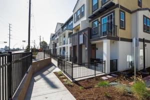 an apartment building with a fence next to a sidewalk at Milpitas 1br w ac nr movies mall dining SFO-1639 in Milpitas