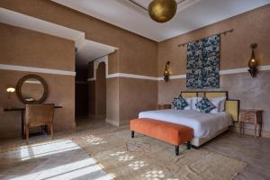 a bedroom with a bed and a mirror and a table at The Levantine in Marrakesh +48 photos