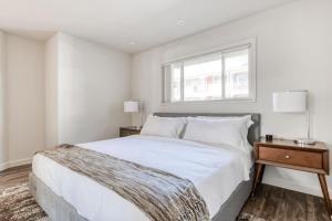 a white bedroom with a large bed and a window at Mountain View 2br w pool patio nr Caltrain SFO-1640 in Mountain View +6 photos