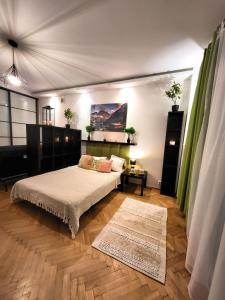 a bedroom with a bed and a table and a rug at KS M Centrum in Warsaw