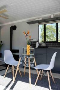 a kitchen with a glass table and two chairs at Luxury cabin in the Swellendam valley, W.C. in Swellendam