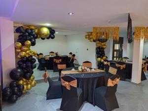 a banquet hall with black and gold balloons and tables at Hotel Thirty Five in Lagos
