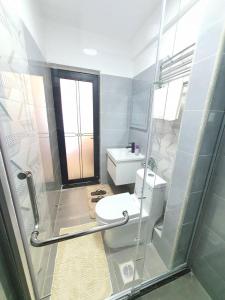 a bathroom with a toilet and a sink at Khomes cosy studio in Nairobi