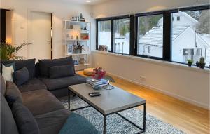 a living room with a couch and a table at Nice Home In Vrmd With Kitchen in Värmdö