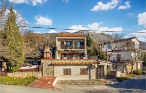a large stone house with a balcony on top of it at Cozy Home In Cesarica With Kitchen in Cesarica