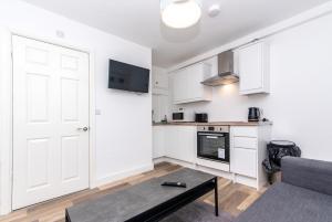 a living room with a white door and a table at 1-BR Gem in Sheffield - Easy City Centre Access in Sheffield