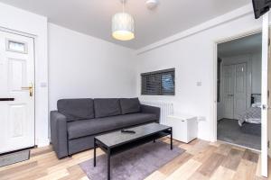 a living room with a couch and a table at 1-BR Gem in Sheffield - Easy City Centre Access in Sheffield