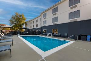 a swimming pool in front of a building at Fairfield by Marriott Chesapeake in Chesapeake