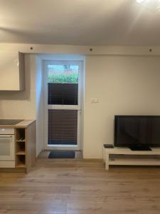 a living room with a television and a window at Ferienwohnung Mescherin 3 in Mescherin