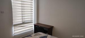 a room with a fireplace and a window with blinds at * APARTAMENTO CON HERMOSA VISTA in Manizales