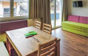 a room with a table and chairs and a room with a couch at Awesome Apartment In Wagrain With Kitchen in Wagrain